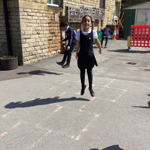Y3 children jumping in the air to see their shadows.